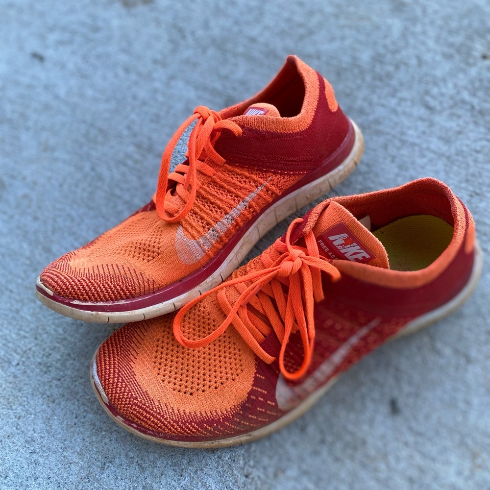 Nike orange and red flyknit tennis/running shoes